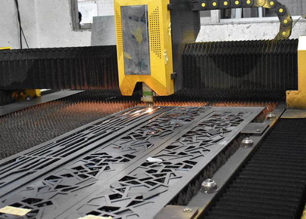 A computer screen showing nesting software optimizing parts on a sheet of metal